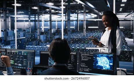 Team of data center developers doing brainstorming, monitoring neural network AI LLM. Teamworking colleagues in high tech facility oversee servers powering machine learning processes, camera A