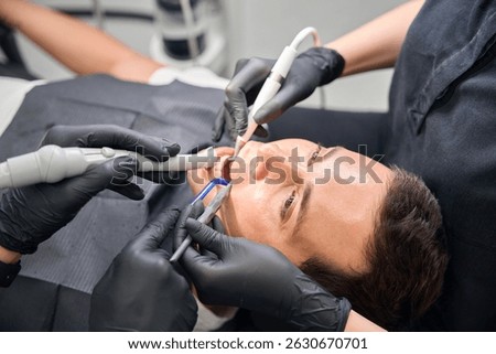 Team of dental professionals using different tools to provide smile makeover