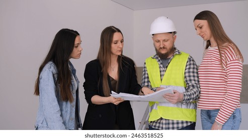 Team of designers reviews blueprints, ensuring precision in home interior work. Decision-making process captured, strategic and collaborative. Decisive action in design ensures project success. - Powered by Shutterstock