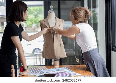 Team designers are working to process of making precise adjustments to the garment - Powered by Shutterstock