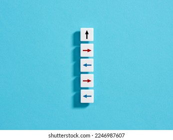 Team disagreement or dysfunction. Lack of teamwork and collaboration. Disobedience to the leader, insubordination and lack of coordination. Arrows on white blocks pointing in different directions.