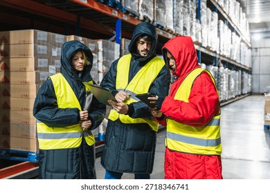 Team of diverse workers checking inventory and using digital tablet in a low temperature cold storage logistics warehouse - Powered by Shutterstock - Get 15% off with code: PIKWIZARD15
