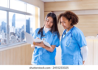 Team of diversity doctor and nurse are discussing and brainstorming on patient medical record after diagnosis for precise care plan with experienced physician specialist - Powered by Shutterstock