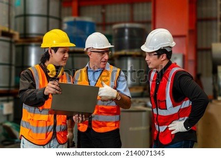 Team of diversity worker inspecting inside the steel manufacturing factory while listening to senior manager advice on improvement of capacity and productivity concept