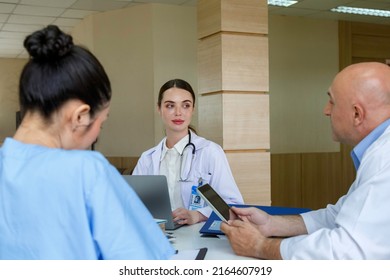 Team Doctor, Nurse And Internship Doctor Talking And Discussing About Surgery Treatment Patientâ€™s Case While Sitting In The Meeting Room Office In Hospital. Healthcare And Medical Concept.