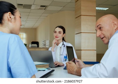 Team Doctor, Nurse And Internship Doctor Talking And Discussing About Surgery Treatment Patient’s Case While Sitting In The Meeting Room Office In Hospital. Healthcare And Medical Concept.