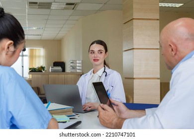 Team Doctor, Nurse And Internship Doctor Talking And Discussing About Surgery Treatment Patient’s Case While Sitting In The Meeting Room Office In Hospital. Healthcare And Medical Concept.