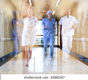 Team of doctor and nurse running in hallway of hospital