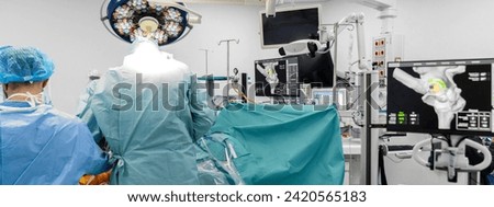 Team of doctor perform total hip arthroplasty replacement surgery in osteoarthritis patient inside the operating room. robot-assisted - robotic hip and knee replacement surgery	