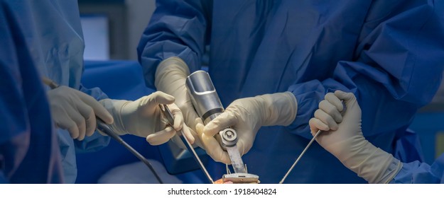 Team of doctor perform total knee replacement surgery in osteoarthritis patient inside the operating room. Selective focus at oscillating saw thar cutting the bone.Close up photo.Medical concept.