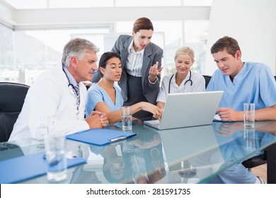 Team Of Doctors And Businesswoman Having A Meeting In Medical Office