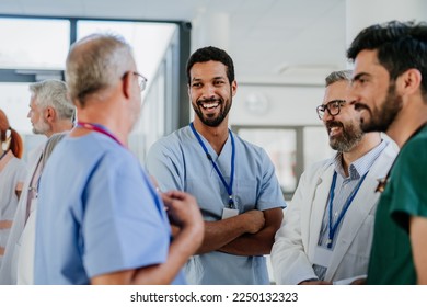 Team of doctors discussing something at hospital corridor. - Powered by Shutterstock