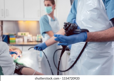 Team of doctors performing endoscopy in hospital examining stomach of patient  - Shutterstock ID 1154720920