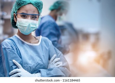 Team of doctors or surgeons in hospital surgery operating emergency room during coronavirus or covid-19 crisis, medical concept.