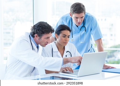 Team of doctors working on laptop in medical office
