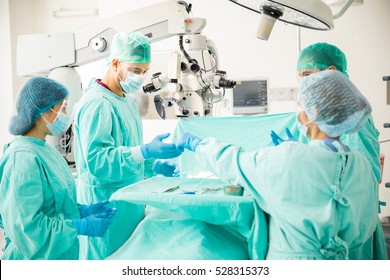 Team Of Doctors Working Together During A Heart Surgery In An Operating Room At A Hospital