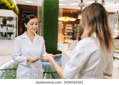 Team of doctors working together on patients file at hospital. Medical staff analyzing report and working at clinic. Female doctor having discussion in hallway with nurse. Concept of healthcare. - Powered by Shutterstock