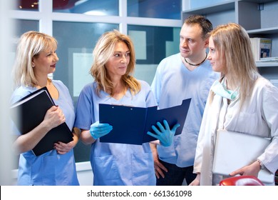 Team of doctors working together on patients file.