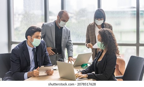 A Team Of Dynamic Managers With Face Masks Have A Meeting To Design For A New Business Project. Modern Office Workers Use Computer And Technology For Collective Decision