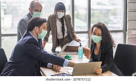 A Team Of Dynamic Managers With Face Masks Have A Meeting To Design For A New Business Project. Modern Office Workers Use Computer And Technology For Collective Decision