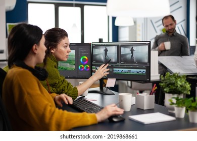 Team Of Editors Women Working With Modern Studio Post Production Software In Digital Multimedia Company. Video Maker Employees Editing Film Montage In Creative Agency Looking At Computer