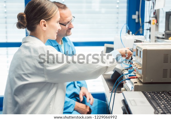 Team Electronic Engineers Testing Product Prototype Stock Photo