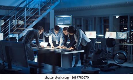 Team Of Electronics Development Engineers Standing At The Desk With 3D Printer And PCB Motherboards. Specialists Working On Ultra Modern Industrial Design, Using Advanced Technology.