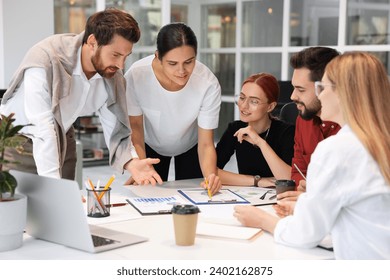 Team of employees working together in office - Powered by Shutterstock