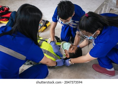 Team EMS Paramedic First Aid For Head Injuries. Employee Accident In Construction Site Work. Paramedic Team First Aid Builder Accident In Site Work. First Aid Procedure. Emergency Service.