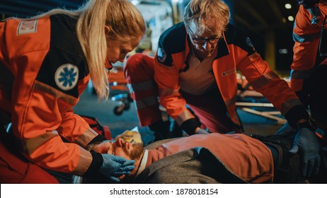 Team Of EMS Paramedics Bring A Stretcher From Ambulance Vehicle And Help An Injured Young Person. Emergency Care Assistants Arrived On The Scene Of A Traffic Accident On A Street At Night.Blur