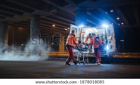 Team of EMS Paramedics React Quick to Bring Injured Patient to Healthcare Hospital and Get Him Out of Ambulance on a Stretcher. Blur