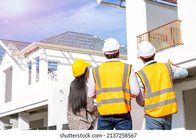 Team engineer and architects are meeting to plan for new project measuring layout of building blueprints in construction site,Construction residential new house in progress at building site. - Shutterstock ID 2137258567