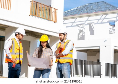 Team Engineer And Architects Are Meeting To Plan For New Project Measuring Layout Of Building Blueprints In Construction Site,Construction Residential New House In Progress At Building Site.