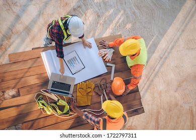 Team of engineer and architects working, meeting, discussing,designing, planning, measuring layout of building blueprints at construction site,Top view,Construction concept. - Powered by Shutterstock