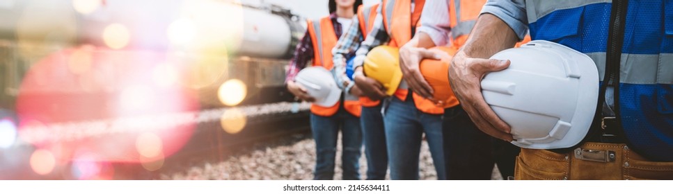 Team engineer holding helmet standing in row on site work, banner cover design.