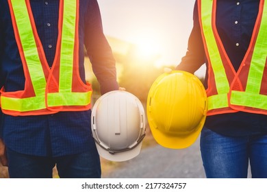 Team  Engineer Holding Safety Helmet On Factory Background