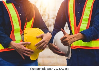 Team  Engineer Holding Safety Helmet On Factory Background