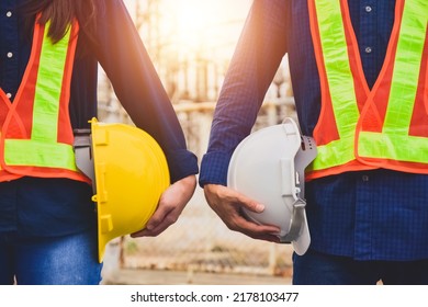 Team  Engineer Holding Safety Helmet On Factory Background