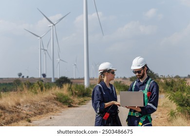 Team engineer wearing safety uniform holding laptop discussed plan about renewable energy at station energy power wind. technology protect environment reduce global warming problems. - Powered by Shutterstock