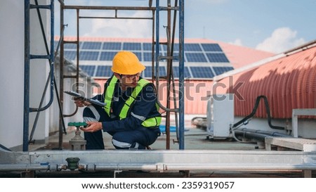 A team of engineers is checking the air conditioning cooling system of a major building or industrial facility.