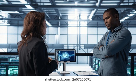 Team of engineers in data center with tablet integrating AI driven automation tools, doing maintenance. Teamworking colleagues in server room using artificial intelligence, camera B