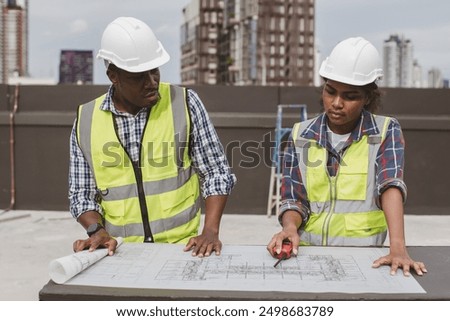 Team Engineers with draft plan of building on constructing site. Engineer work on site. engineer visit and inspection site engineer. Inspector engineer check and working on site.