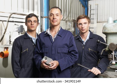 Team Of Engineers In Factory