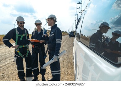 A team of engineers is inspecting the construction of wind turbines and surrounding structures in remote areas to produce clean electricity and help with sustainability and reduce global pollution.