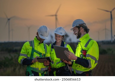 Team Engineers men and woman checking and inspecting on construction with sunset sky. people operation. Wind turbine for electrical of clean energy and environment. Industrial of sustainable. - Powered by Shutterstock