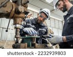 Team engineers practicing maintenance Taking care and practicing maintenance of old machines in the factory so that they can be used continuously.