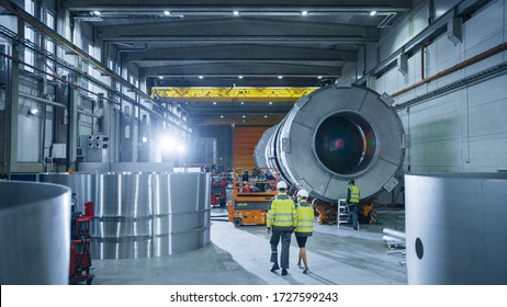 Team of Engineers and Professionals Working on a Pipe Manufacturing Factory. Steel Metalwork Facility for Construction of Oil, Gas and Fuel Pipeline Transportation Products. - Powered by Shutterstock