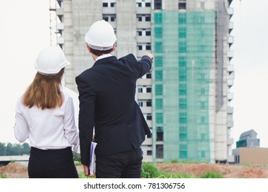 Team Engineers Surveying Land For Real Estate Property For Investment. Businessman And Businesswoman Surveying Land For Industrial Project.