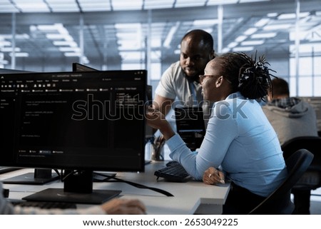 Team of engineers talking in server hub, ensuring compliance with industry standards and regulatory requirements. Data center teamworking colleagues conducting security audits