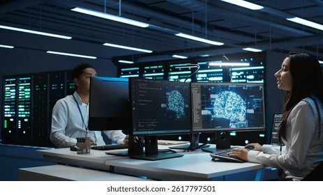 Team of engineers using AI tech on computer to do checkup in server room. Data center workers using artificial intelligence technology to process datasets for training, camera B